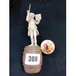 BONE FIGURE OF MAESTRO ON WOODEN BARREL