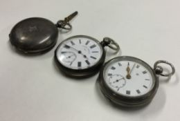 A group of three silver pocket watches with white enamelled dials.
