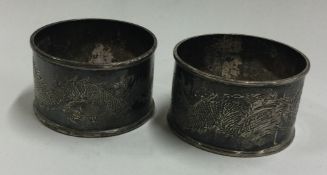 A pair of engraved Chinese silver napkin rings.