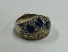 A large 18 carat gold sapphire and diamond dress ring.