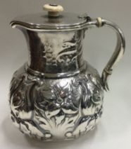 A good 19th Century American silver chased mug with hinged lid bearing import marks.