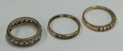 Two 9 carat diamond mounted half eternity rings together with one other.