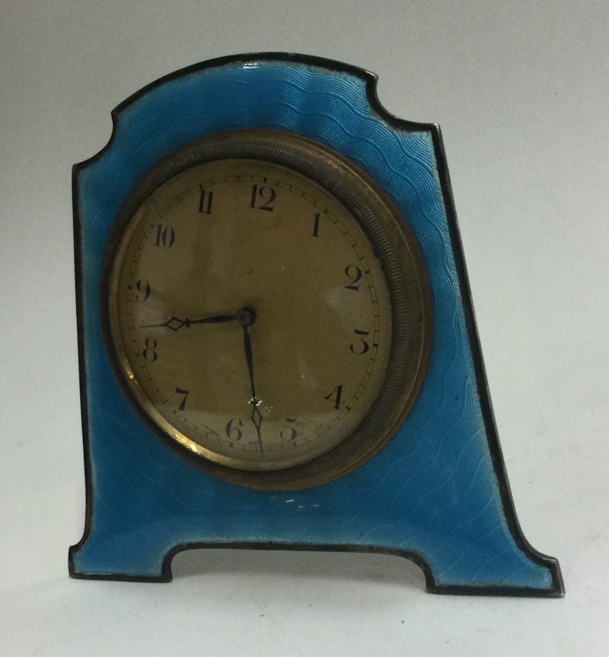 A silver and blue enamelled clock.