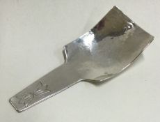A stylish silver caddy spoon of textured form.