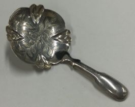 A good George III bright cut silver caddy spoon.