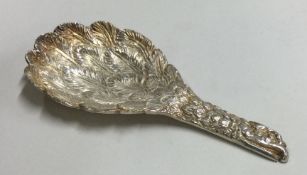 A silver caddy spoon in the form of an eagle.