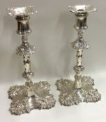 A heavy pair of cast silver candlesticks of typical form. London 1767.