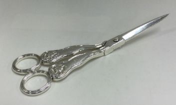 A good pair of William IV silver grape scissors with shell decoration. London 1837.