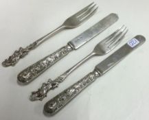 A good matched pair of Chinese silver knives together with forks.