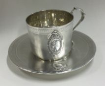 A French silver cup and saucer with engine turned decoration.