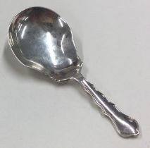 A George III silver caddy spoon with bright cut decoration.