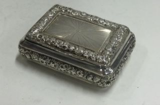 A chased George III silver snuff box with bright cut decoration.