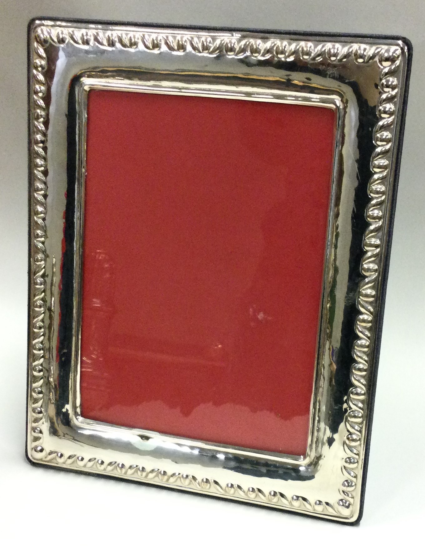 A large rectangular silver photo frame with velvet back.