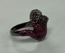 An unusual ruby and diamond mounted ring in the fo