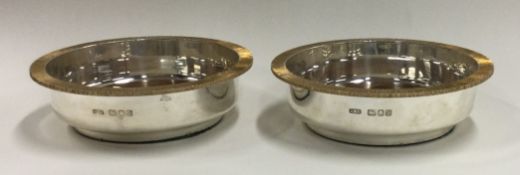 CHRISTOPHER LAWRENCE: A fine pair of silver and silver gilt coasters.