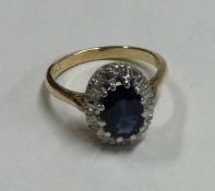 A large oval sapphire and diamond crossover ring in 18 carat gold setting.