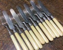 A collection of silver collared bone cutlery.