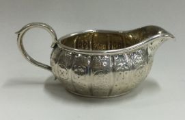 An engraved silver cream jug. London 1868.