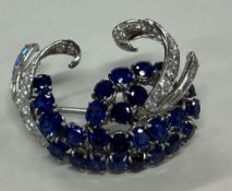 A good quality sapphire and diamond oval bow brooc