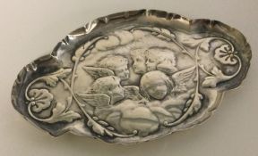 A silver chased tray embossed with cherubs. London 1903.