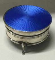 A silver and blue enamelled jewellery box on feet.