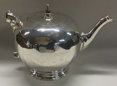 A good George III silver teapot with hinged top on ball feet. London 1736.