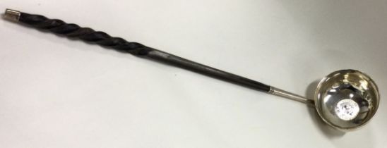 A heavy Georgian silver toddy ladle with whalebone handle.