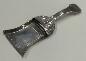 A George III silver figural caddy spoon in the form of a shovel.