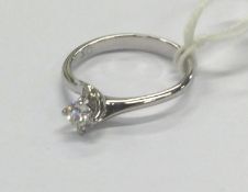 A small diamond single stone ring in 18 carat claw mount.
