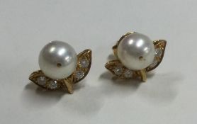 A good pair of diamond set ear pendants with floral decoration.