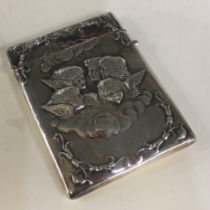 A large heavy silver card case decorated with cherubs.
