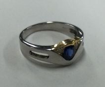 A good quality sapphire and diamond two colour 18 carat gold ring with pierced decoration.