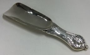A heavy American silver shoe horn with chased decoration.
