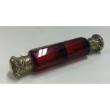A silver gilt and red glass double scent bottle.