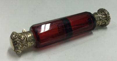 A silver gilt and red glass double scent bottle.