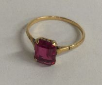 A small 9 carat and red stone ring.