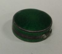 A green enamelled and silver box bearing import marks.