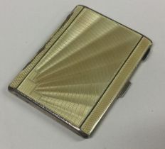 A silver and yellow enamelled cigarette case.