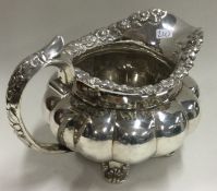 DUBLIN: A good William IV Irish silver jug embossed with flowers.