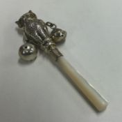 A Sterling silver rattle in the form of an owl with MOP handle.