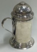 An 18th Century silver muffineer with handle. London 1727.