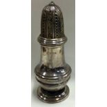 A heavy Georgian style silver sugar caster with lift-off cover.