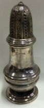 A heavy Georgian style silver sugar caster with lift-off cover.