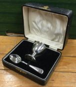 A cased silver egg cup and spoon. Sheffield.