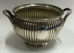 A half fluted Victorian silver sugar bowl with reeded body.
