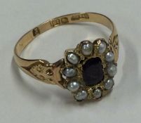 A good ruby and pearl Antique cluster ring in 18 carat gold mount.