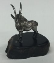 PATRICK MAVROS: A silver figure of an antelope on stand.
