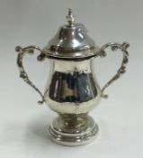 CHESTER: A silver lidded cup.