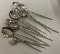 An unusual set of twelve silver ice cream spoons.