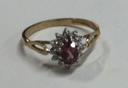 An attractive diamond set cluster ring in two colour gold mount.
